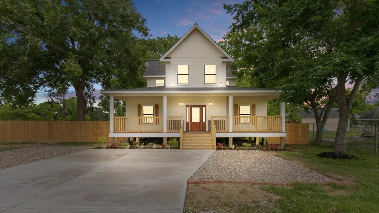 Twilight front exterior of 5-bedroom new-construction farmhouse rental at 10002 Wilma Ln, Beach City TX