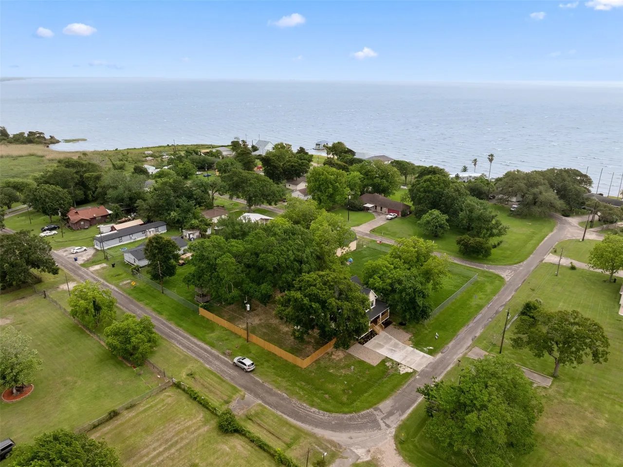 Aerial wide view showing the property, McCollum Park, and Trinity Bay in the background