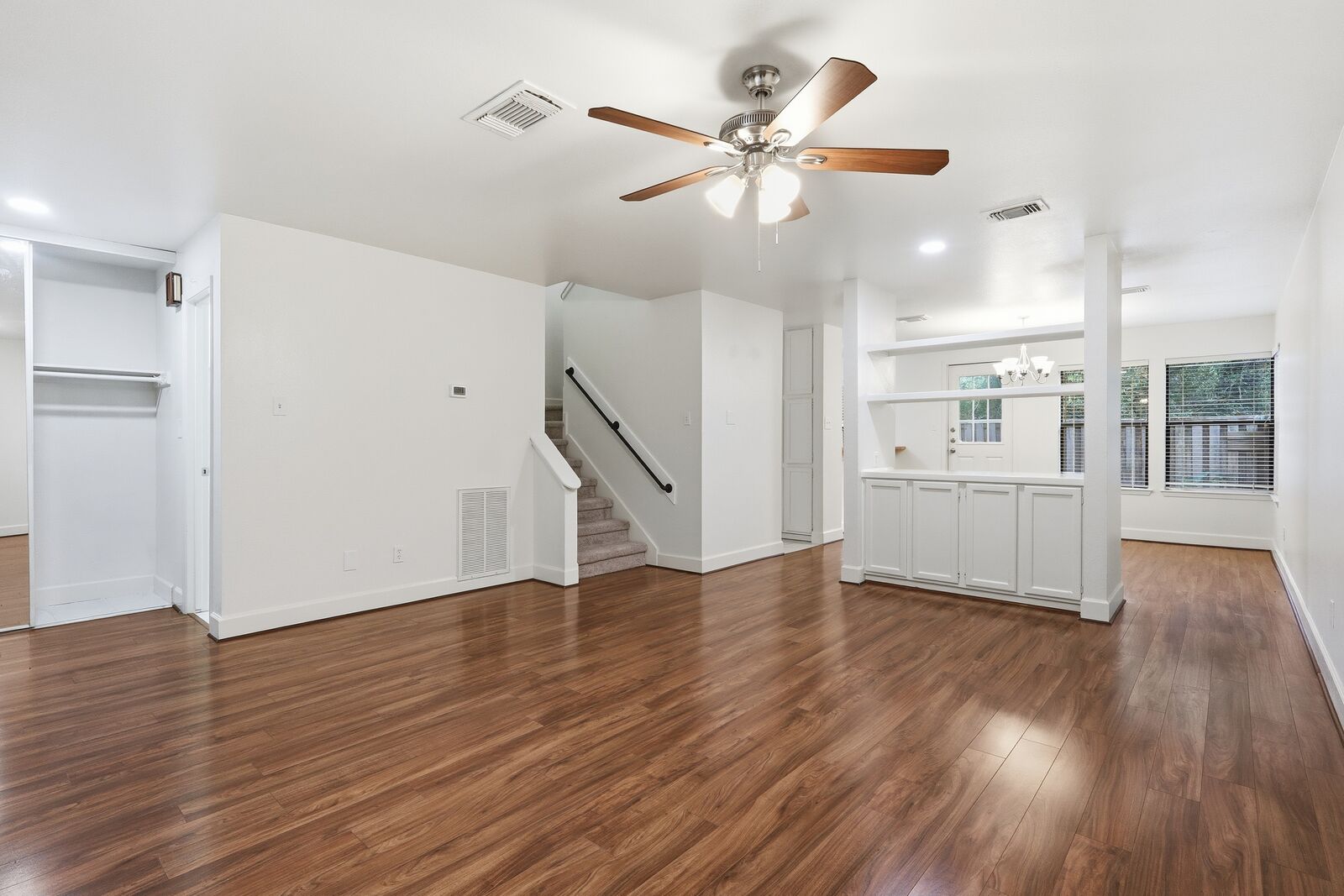 Open first-floor living area looking toward the dining room and staircase