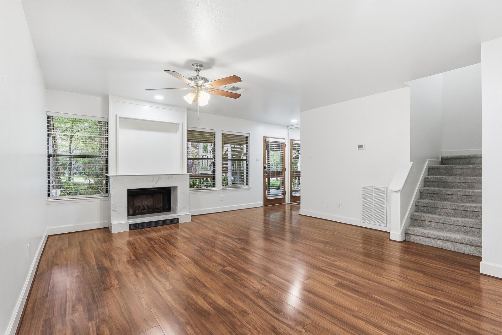 18x15 living room with fireplace, ceiling fan and staircase to the second floor