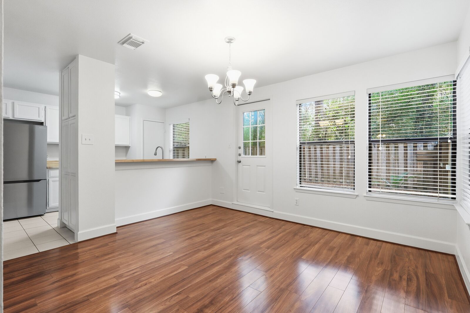 Dining area with chandelier, open to the kitchen breakfast bar