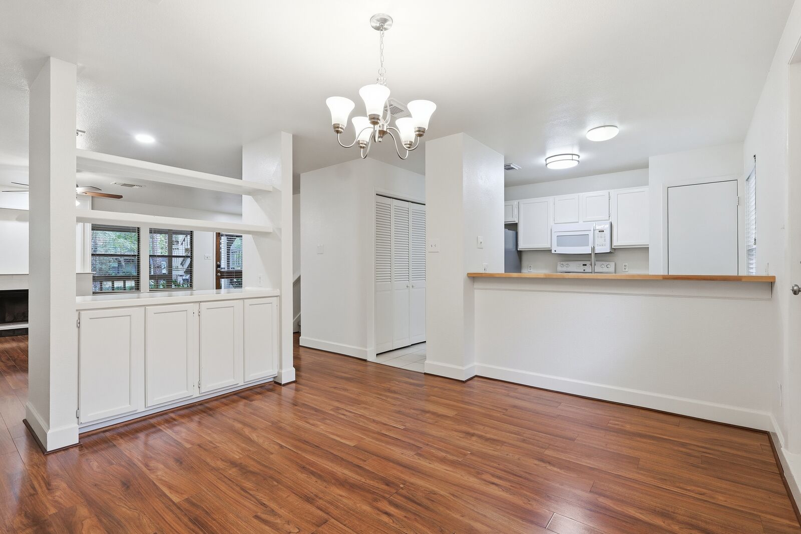 Dining area with built-in cabinets and kitchen pass-through