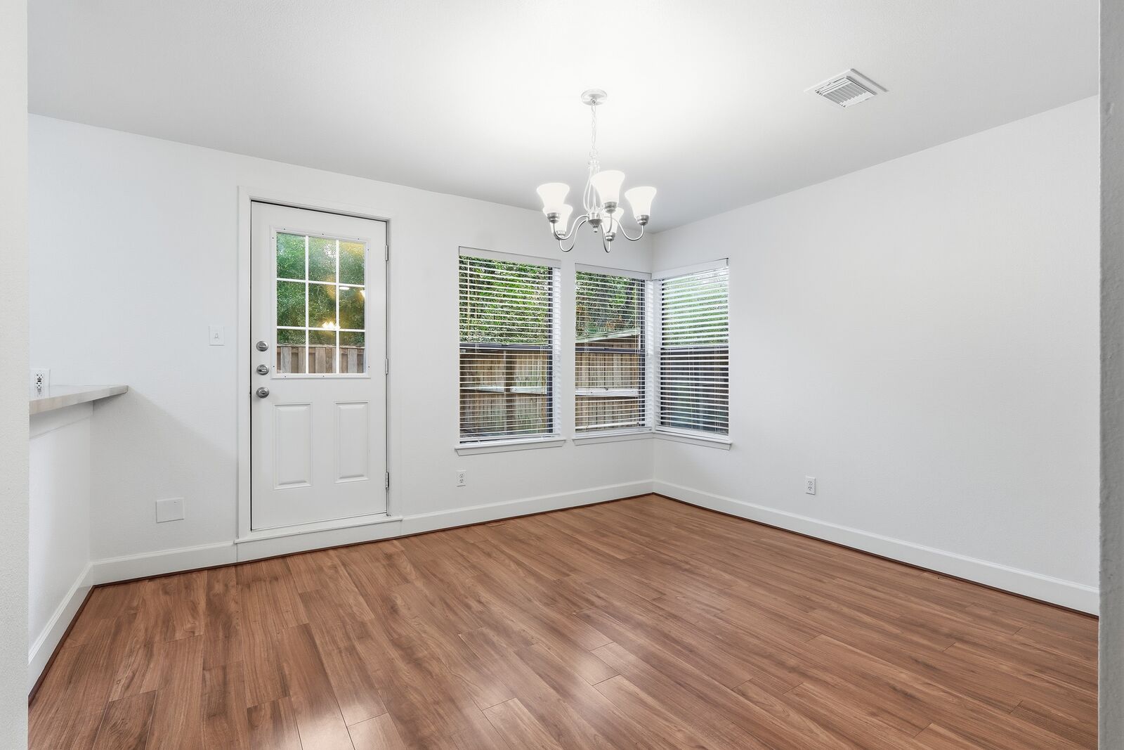 Dining area with chandelier, back door and large windows