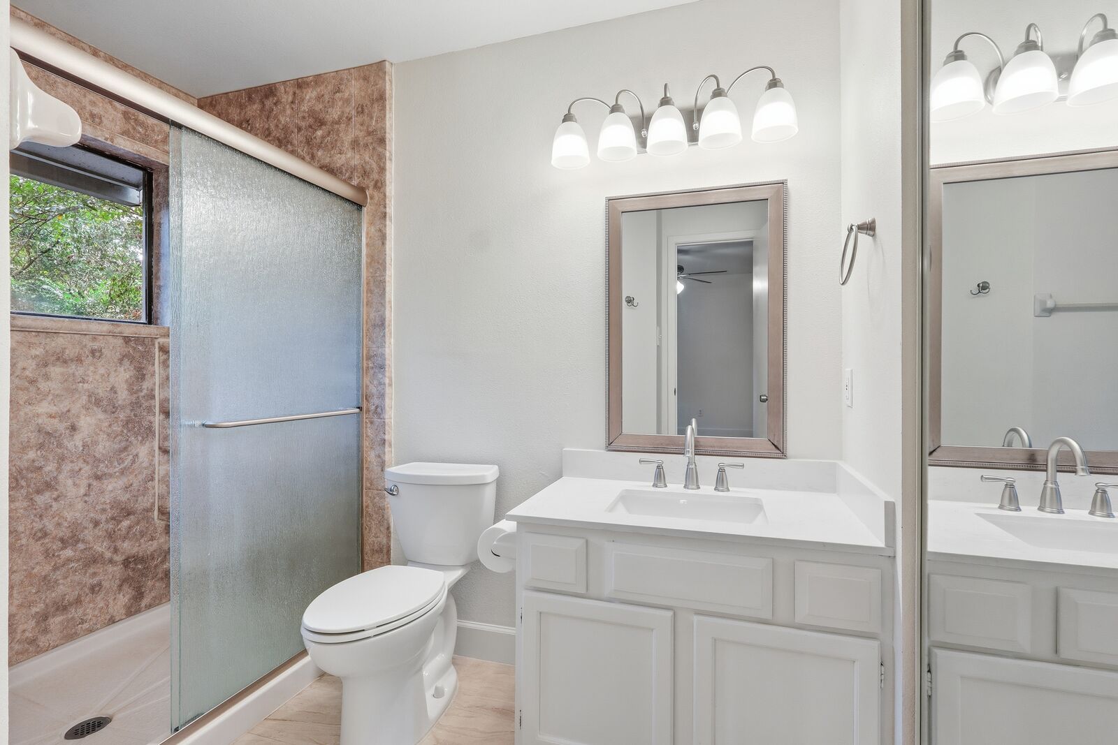 Primary en-suite bath with walk-in shower and vanity