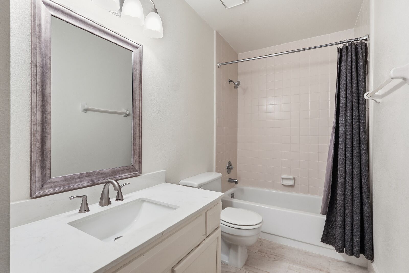 Hall bath with tub/shower combo and vanity