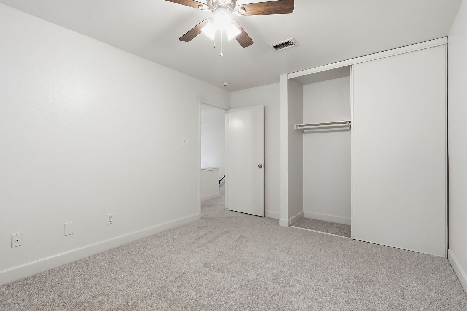 Secondary bedroom with closet and ceiling fan