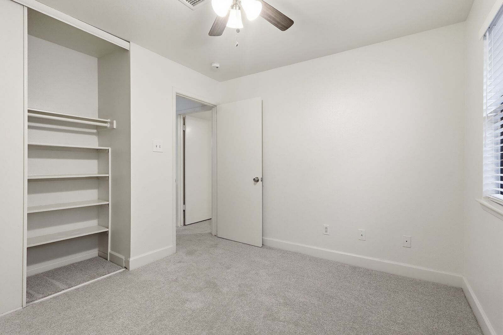 Bedroom with built-in shelving closet