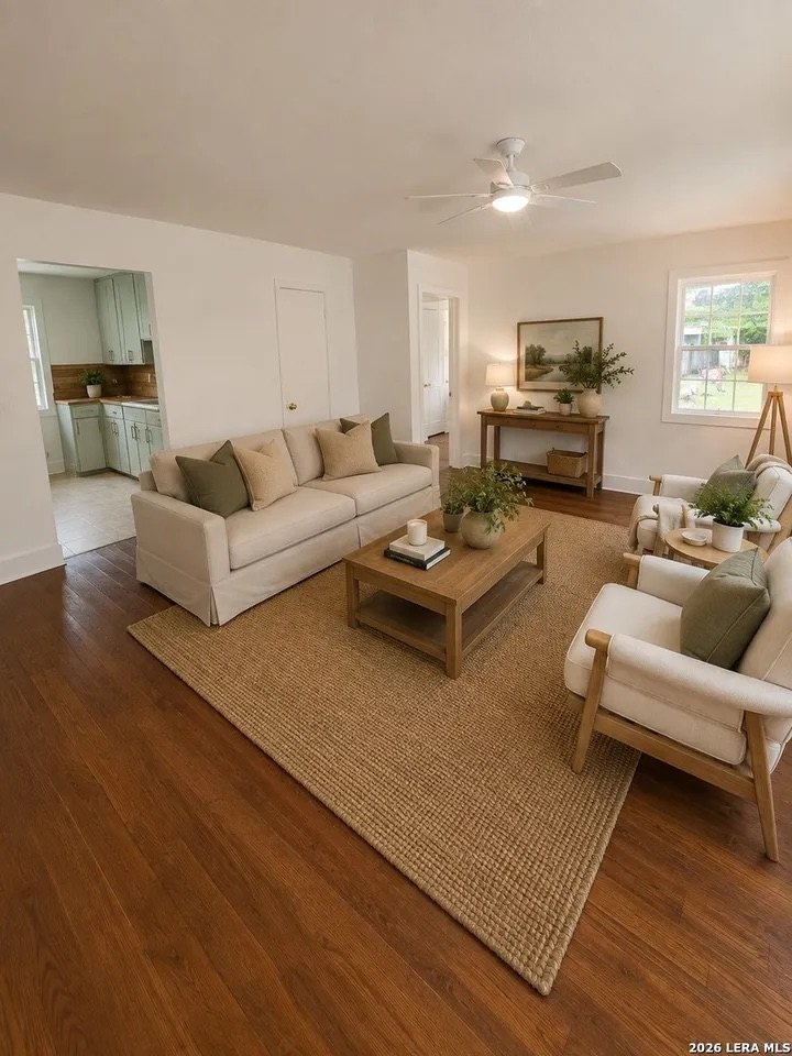Large living room with wood floors and ceiling fan