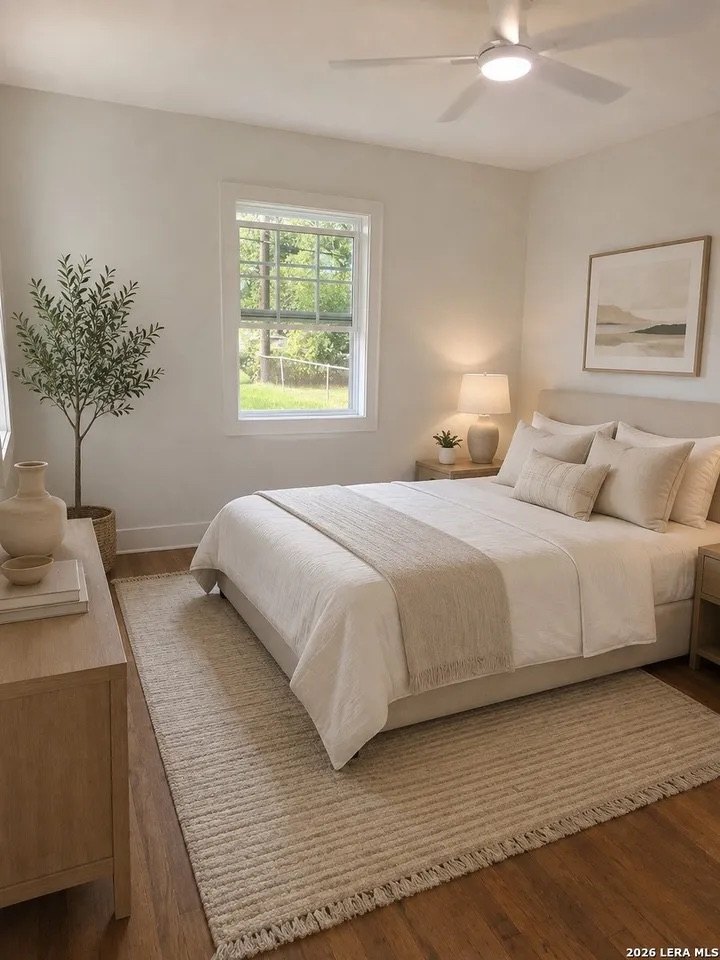 Bedroom with ceiling fan and large window
