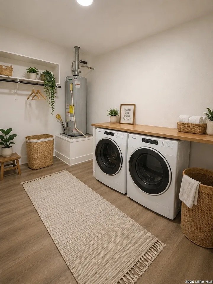 Oversized laundry room with washer/dryer connections and gas water heater