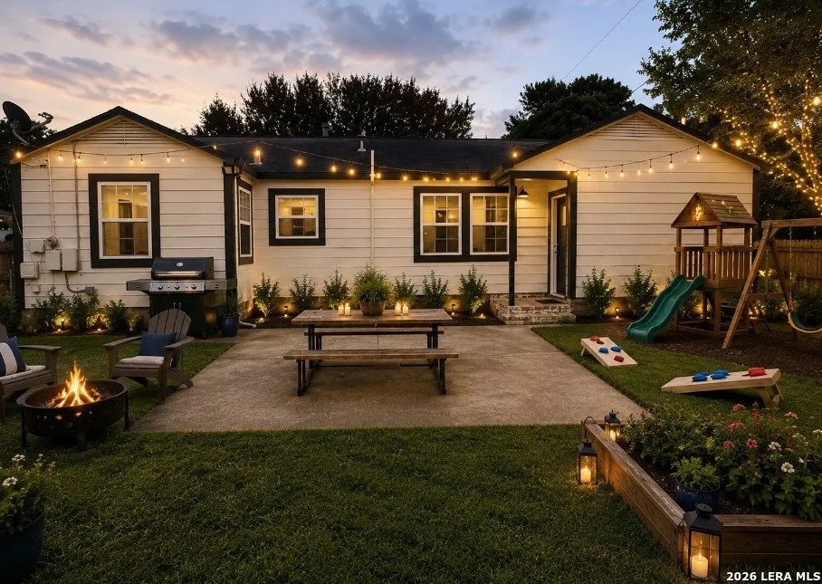 Expansive backyard with patio area and string lights