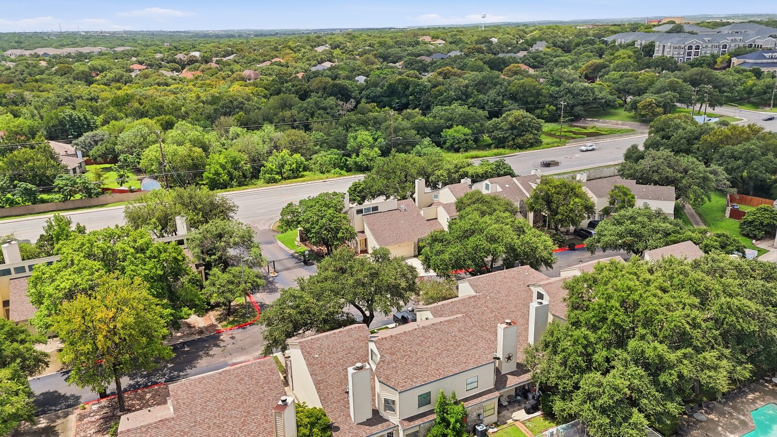 Wide aerial view of the property and surrounding neighborhood