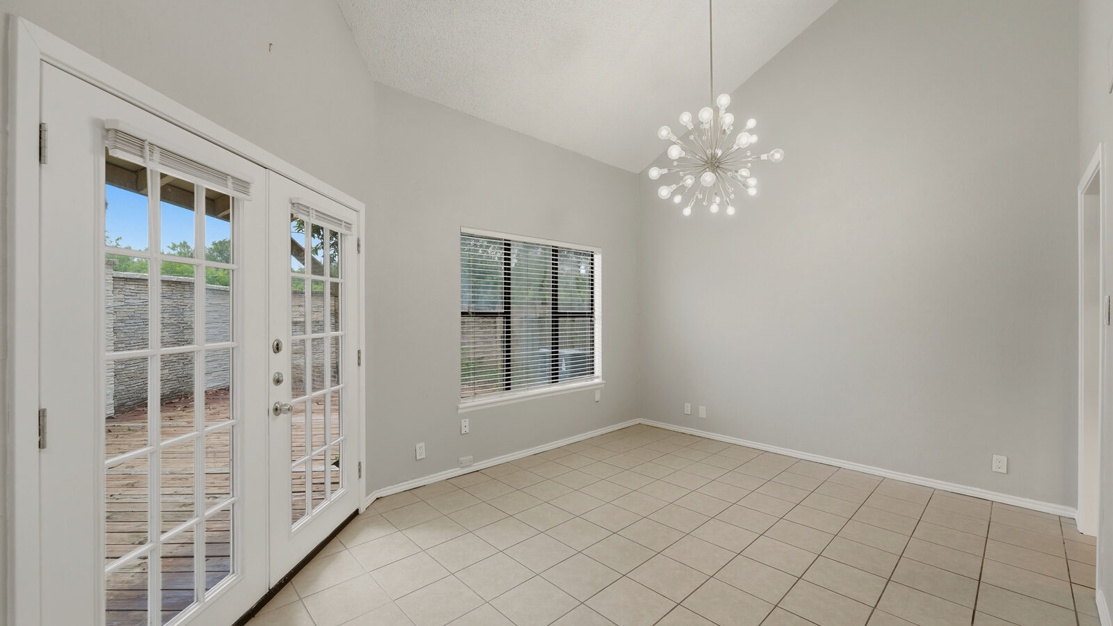 Kitchen with stainless microwave, range, and refrigerator, subway-tile backsplash